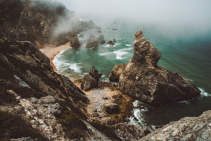 Sentra, Portugal. Moody foggy weather at Praia da Ursa beach on morning. Rough Atlantic Ocean. Sentra, Portugal. Moody foggy weather at Praia da Ursa beach on morning. Rough Atlantic Ocean.
